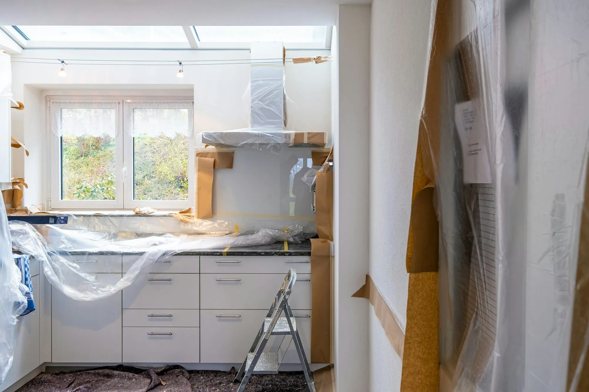 Kitchen during renovation, covered in plastic sheeting