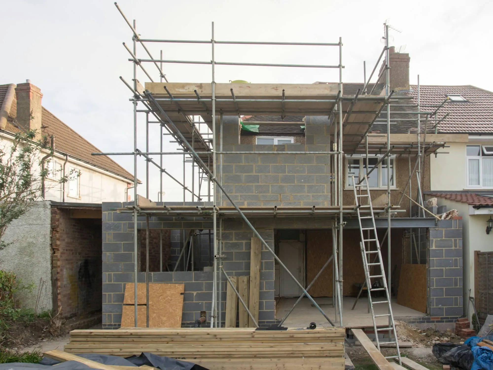 Two-storey extension under construction with scaffolding